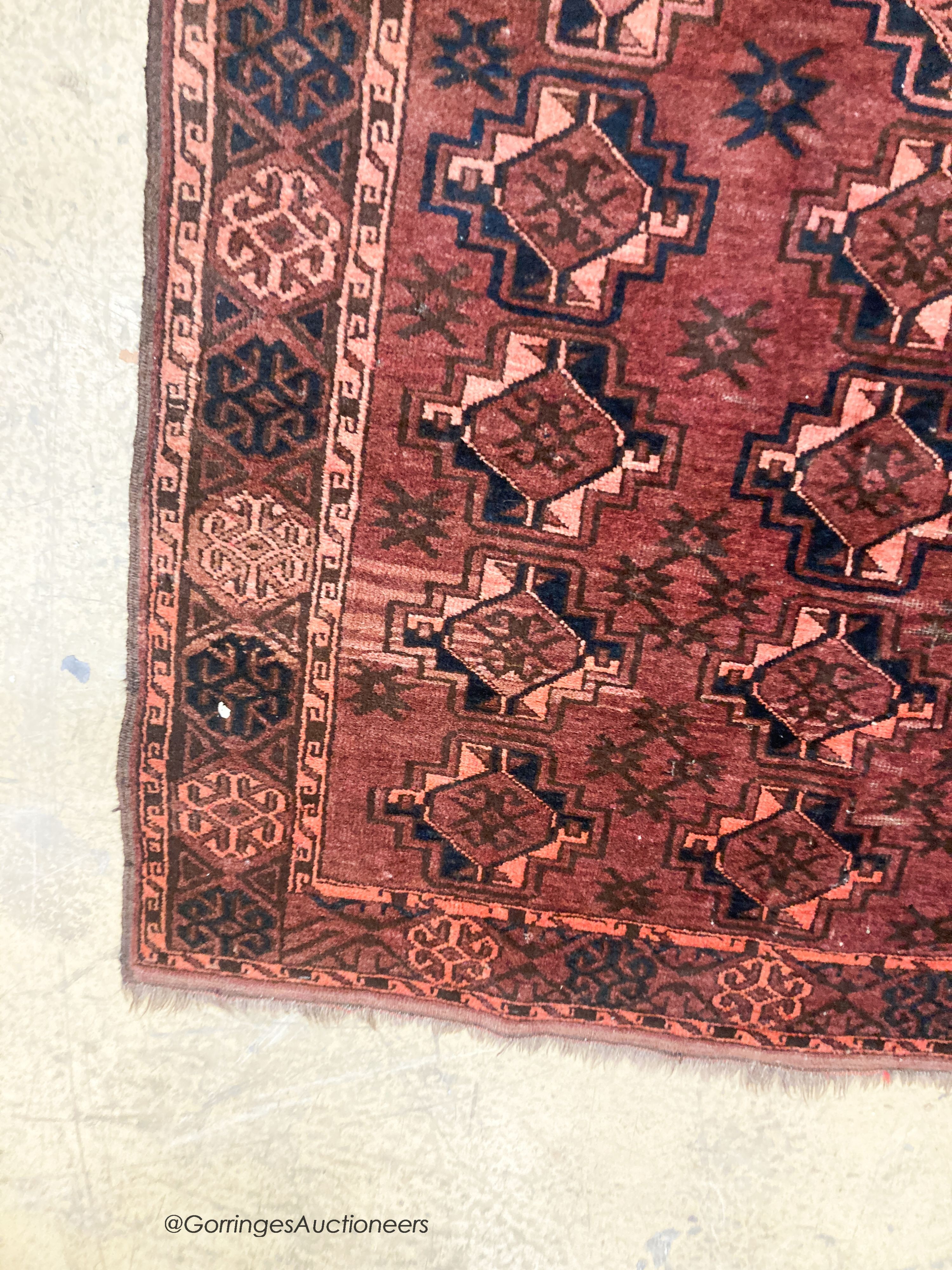 A Bokhara burgundy ground rug, 190 x 105cm